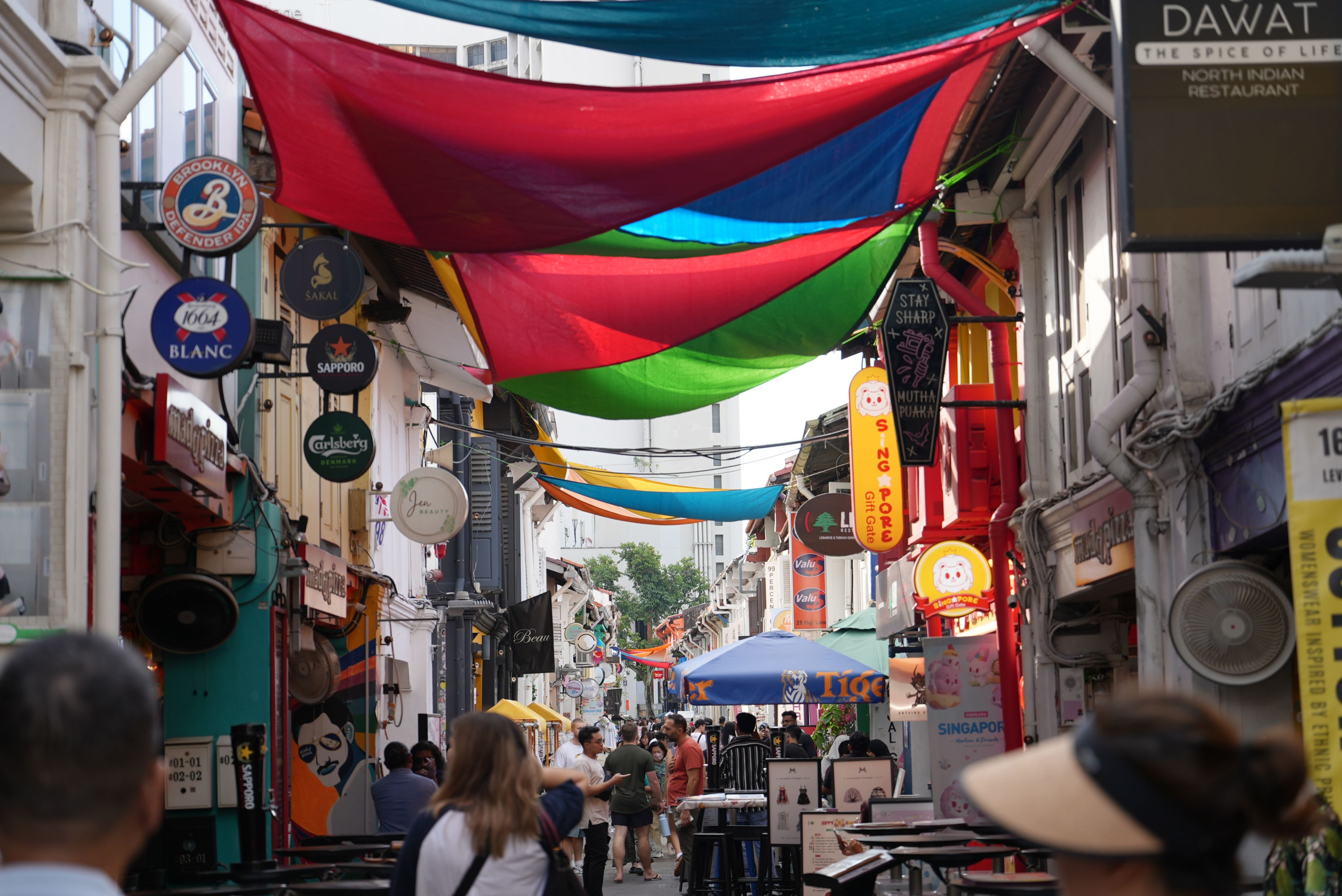 Laughter bounces off the storefronts of Haji Lane. Photo: Stella McGann